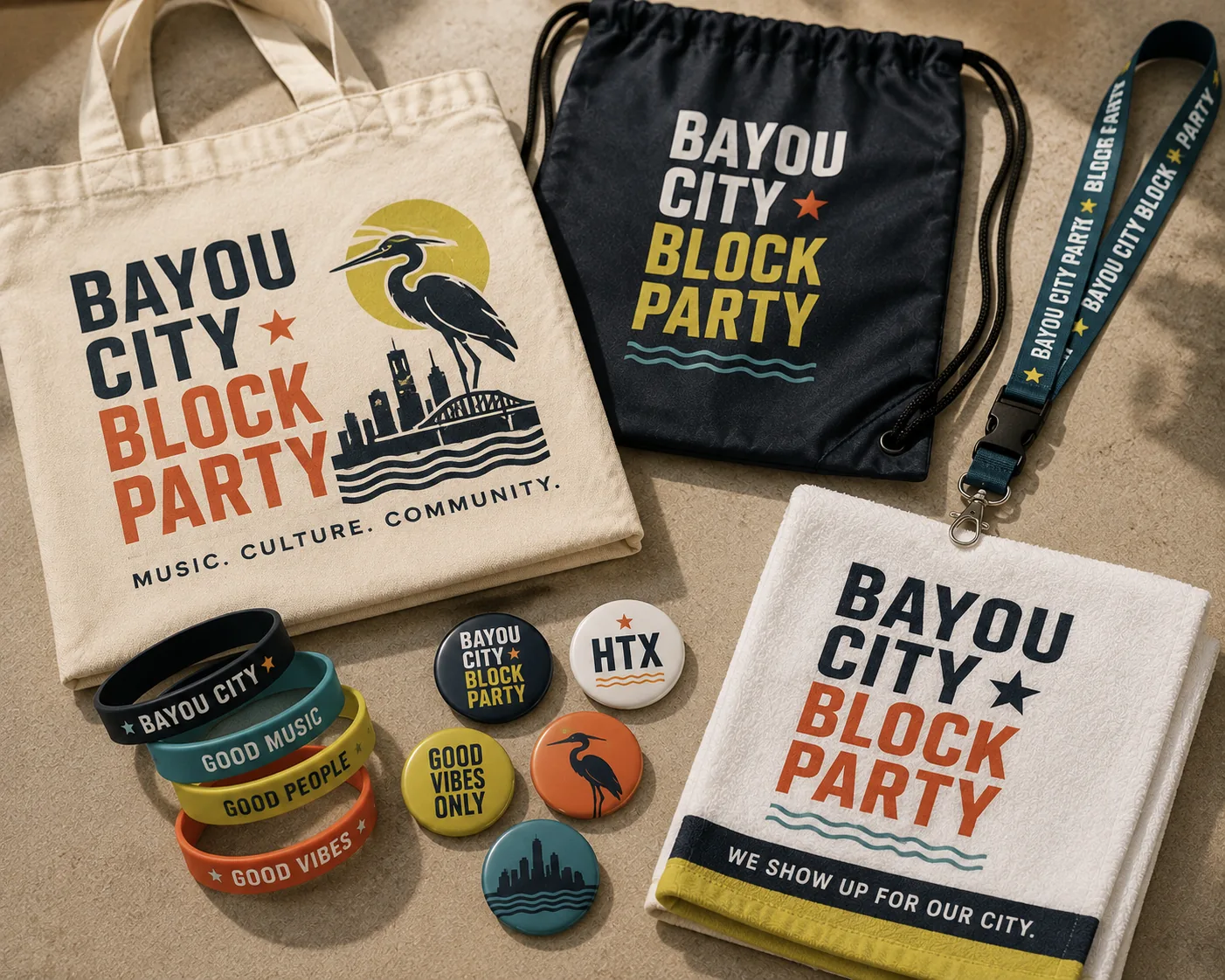 Event giveaway spread: a canvas tote, drawstring bag, lanyard, silicone wristbands, pin-back buttons, and a rally towel, all printed for a Houston block party.