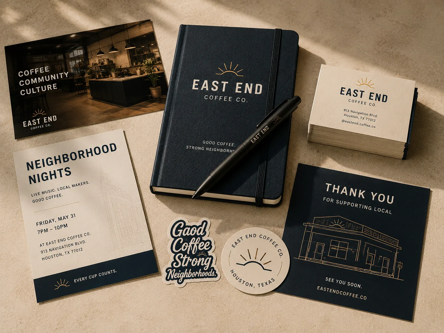 Branded notebook, business cards, postcards, stickers, and a pen for a coffee company, arranged on a warm surface.